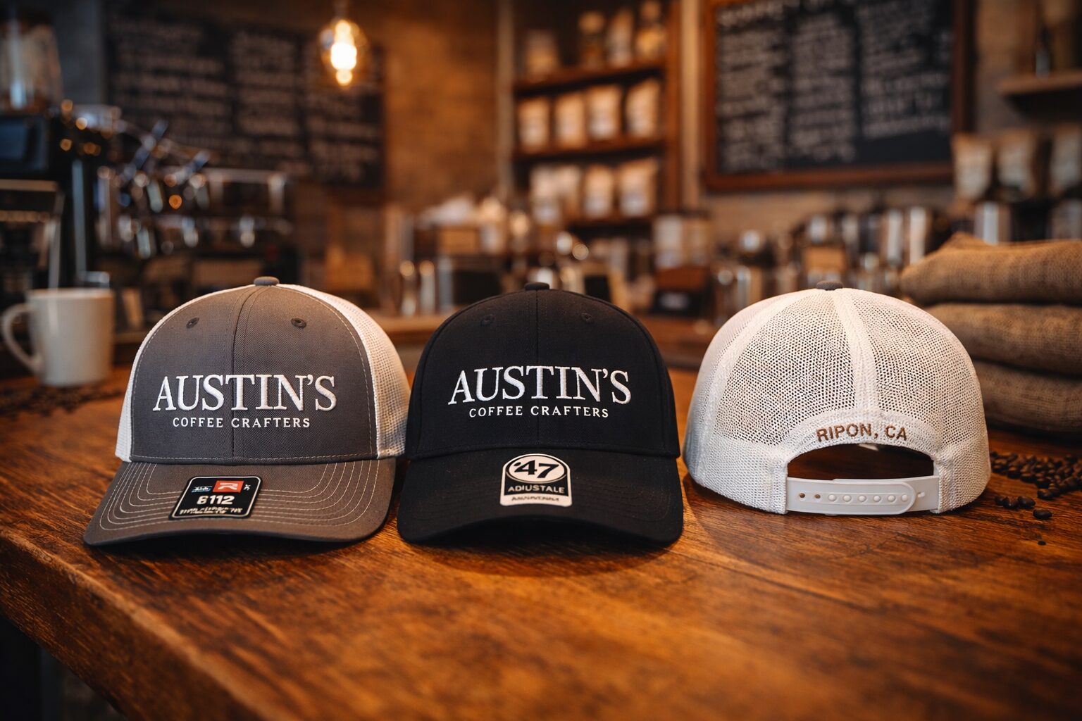 Austin's Coffee Crafters embroidered trucker hats in grey, black, and white
